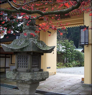 A photo of a temple on Mount Koya in Japan, showing a temple gate and a "toro." A photo of a temple on Mount Koya in Japan, showing a temple gate and a "toro."