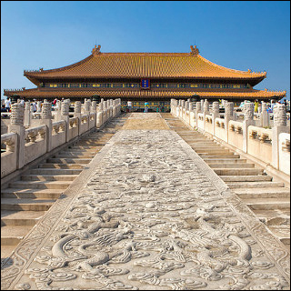 The steps leading up to the Hall of Supreme Harmony in the Forbidden City in Beijing, China. The stairs are separated in the center by a path of dragon carvings. The sky is very blue. The steps leading up to the Hall of Supreme Harmony in the Forbidden City in Beijing, China. The stairs are separated in the center by a path of dragon carvings. The sky is very blue.