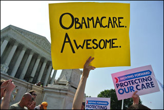 In front of the Supreme Court building, the arm of an unseen demonstrator holds up a huge yellow sign with the words "Obamacare. Awesome." In front of the Supreme Court building, the arm of an unseen demonstrator holds up a huge yellow sign with the words "Obamacare. Awesome."