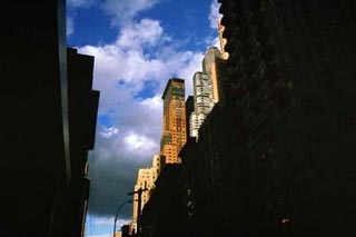 A photograph looking up from the streets of New York City. A photograph looking up from the streets of New York City.