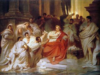 A seated man, wearing a laurel wreath and an elaborate toga, recoils from a group of men, one of whom has a dagger. A seated man, wearing a laurel wreath and an elaborate toga, recoils from a group of men, one of whom has a dagger.