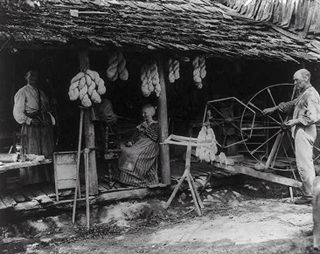 A photograph from 1910 that shows a family at work. A photograph from 1910 that shows a family at work.