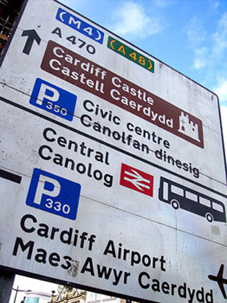 A road sign with directions in English and Welsh. A road sign with directions in English and Welsh.