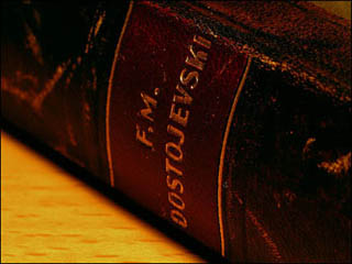 Close-up of the the spine of a book bound in deep brown leather. Close-up of the the spine of a book bound in deep brown leather.