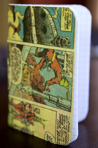 Photo of a grid-paper notebook with comic strip on the cover. The notebook is reinforced with thin cardstock. Photo of a grid-paper notebook with comic strip on the cover. The notebook is reinforced with thin cardstock.