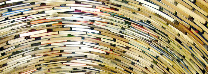 A photograph of stacked books arranged as a statue. A photograph of stacked books arranged as a statue.