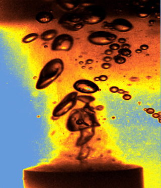 Photo showing gas bubbles form and collapse when a liquid is energized by ultrasound. Photo showing gas bubbles form and collapse when a liquid is energized by ultrasound.