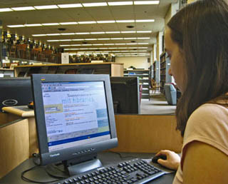 A student at a computer terminal in the library. A student at a computer terminal in the library.