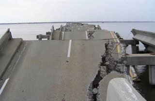 Photo of collapsed concrete bridge roadway over water. Photo of collapsed concrete bridge roadway over water.
