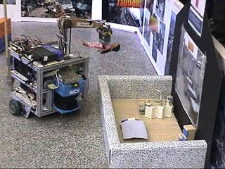 Wheeled robot carrying doll in its arm. Wheeled robot carrying doll in its arm.