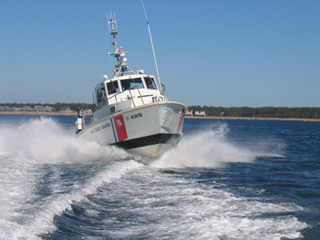 Front view of small powerboat creating waves. Front view of small powerboat creating waves.