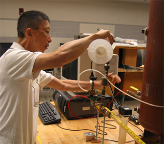 Prof. Wai Cheng works with lab equipment. Prof. Wai Cheng works with lab equipment.