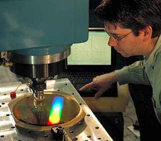 A technician works with a metrology device. A technician works with a metrology device.