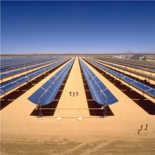 Three people walk between huge mirrored troughs, pointed straight upwards, extending for thousands of feet beyond in all directions. Three people walk between huge mirrored troughs, pointed straight upwards, extending for thousands of feet beyond in all directions.