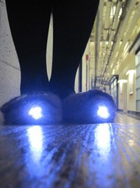 Photo of the illuminated slippers coming down a hallway.