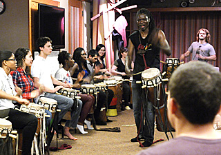 Photo of drummer leading a student drum ensemble. Photo of drummer leading a student drum ensemble.