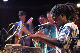 Photo of Lamine Toure performing on the sabar. Photo of Lamine Toure performing on the sabar.