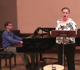 Woman singing with piano accompanist. Woman singing with piano accompanist.