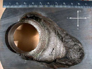 Material damage around a hole on a metal plate Material damage around a hole on a metal plate