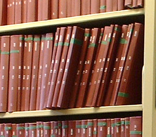 Photo of hardbound academic theses on library shelves. Photo of hardbound academic theses on library shelves.