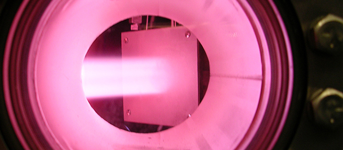 A strong pink glow seen through a reinforced porthole. A strong pink glow seen through a reinforced porthole.