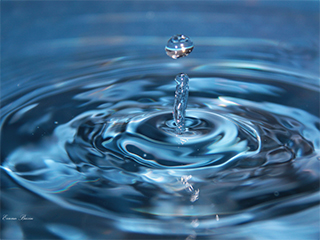 A water drop on top and water column with waves below it. A water drop on top and water column with waves below it.