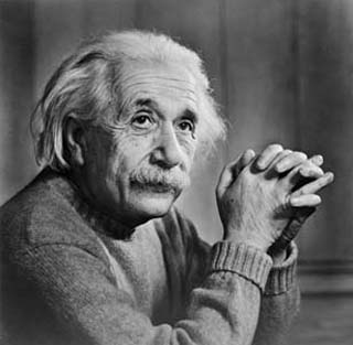 A photograph of Albert Einstein sitting at a table. A photograph of Albert Einstein sitting at a table.