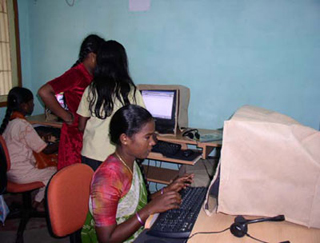 Young girls in India sitting at desktop computers. Young girls in India sitting at desktop computers.
