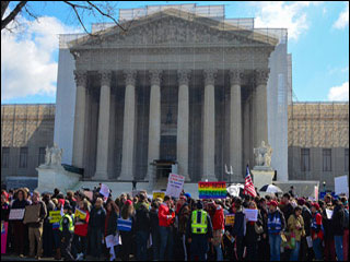 A group of demonstrators stands in front of the U.S. Supreme Court Building. A group of demonstrators stands in front of the U.S. Supreme Court Building.