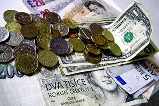 Paper money on a white table, coins strewn on top. Paper money on a white table, coins strewn on top.