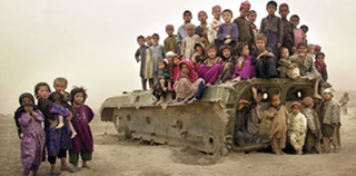 Afgani children gathering on the remains of a tank. Afgani children gathering on the remains of a tank.