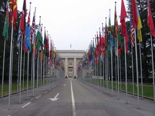 A photograph of the flag lined street that leads to the UN headquarters in Geneva, Switzerland. A photograph of the flag lined street that leads to the UN headquarters in Geneva, Switzerland.