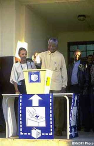 Photograph of Nelson Mandela about to place his ballot in a box during 1994 elections. Photograph of Nelson Mandela about to place his ballot in a box during 1994 elections.