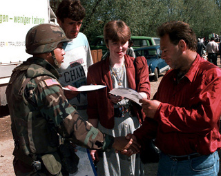 Photogrpah of a U.S. Army soldier greeting local Muslim shoppers. Photogrpah of a U.S. Army soldier greeting local Muslim shoppers.