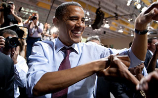 In a crowd, President Obama shakes hands. In a crowd, President Obama shakes hands.