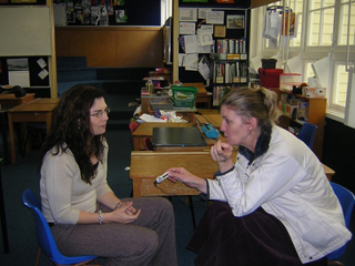 Photograph of one person interviewing another. Photograph of one person interviewing another.