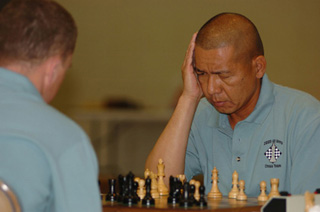 A photograph of two men playing chess. A photograph of two men playing chess.
