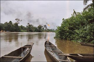 Photo showing canoes on a river with smoke in the background. Photo showing canoes on a river with smoke in the background.
