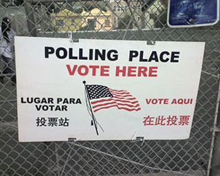 A sign that says Polling Place Vote Here. A sign that says Polling Place Vote Here.