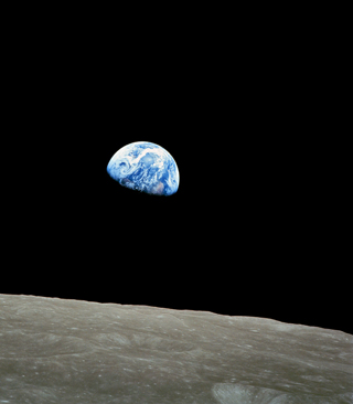 Photo of the earth appearing to rise over the surface of the moon. Photo of the earth appearing to rise over the surface of the moon.