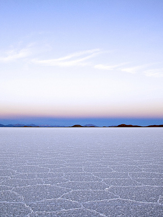 Sun beginning to rise over salt flats. Sun beginning to rise over salt flats.