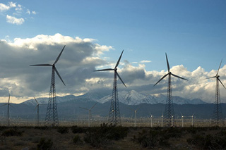 Windmills in a wind farm, mountains in the background. Windmills in a wind farm, mountains in the background.