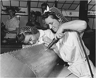Photo of female trainees working on a practice bomb shell, 1942. Photo of female trainees working on a practice bomb shell, 1942.