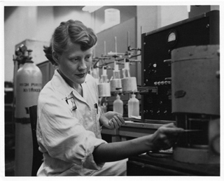 Black and white photo of a young woman working in a chemistry lab. Black and white photo of a young woman working in a chemistry lab.