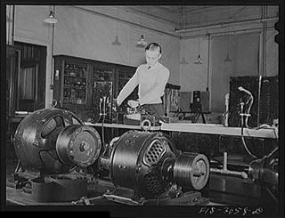 A black and white photograph of Jim Tillma in the electrical engineering laboratory. University of Nebraska, Lincoln. A black and white photograph of Jim Tillma in the electrical engineering laboratory. University of Nebraska, Lincoln.