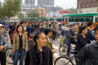 Pedestrians, bicyclists, and buses during rush hour traffic. Pedestrians, bicyclists, and buses during rush hour traffic.