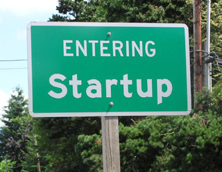 Photo of town sign that reads: "Entering Startup." Photo of town sign that reads: "Entering Startup."