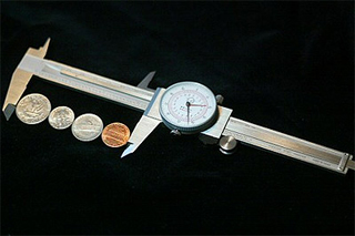 Calipers around several coins. Calipers around several coins.