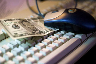 A keyboard, mouse, and five dollar bill. A keyboard, mouse, and five dollar bill.