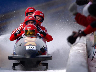 Bobsled team competing in Winter Olympics. Bobsled team competing in Winter Olympics.